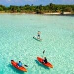 Kayaking and paddleboarding in turquoise water.