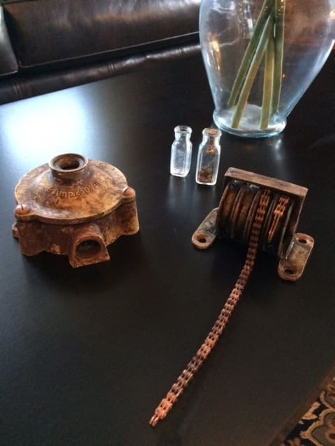 Antique metal parts and small bottles.