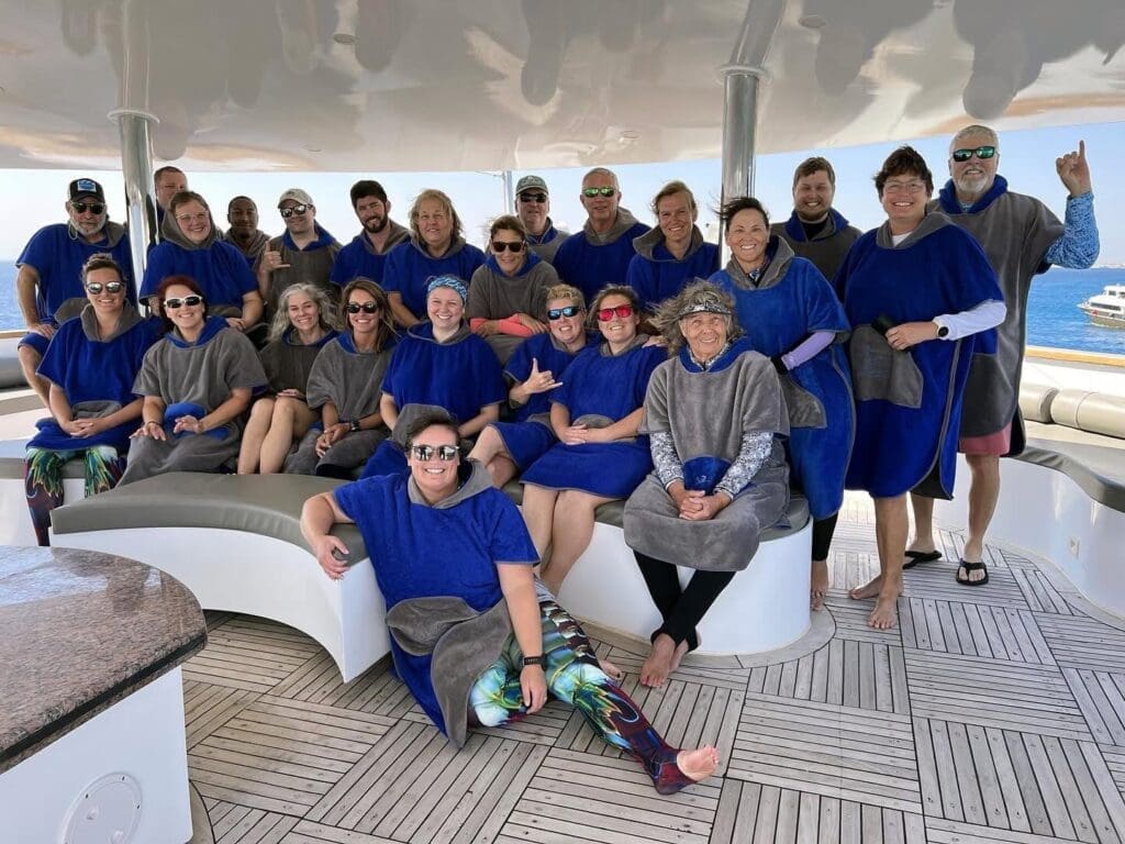 Group wearing ponchos on a boat deck.