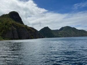 Mountainous coastline under a partly cloudy sky.