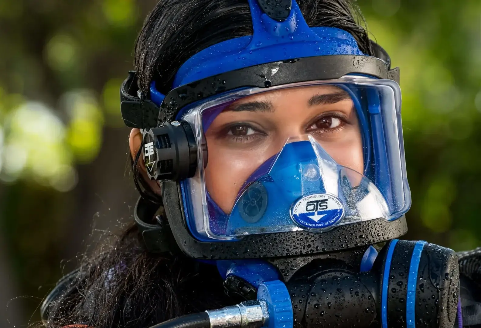 Person wearing a blue scuba diving mask.