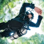 Scuba diver floating in clear water.